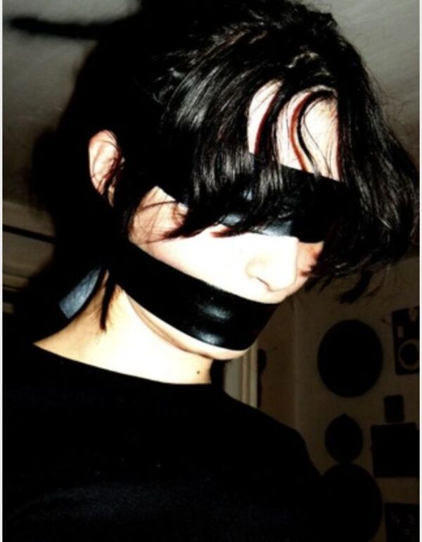 Dark, low-key portrait of Wendie in a leather blindfold — fine-art editorial.